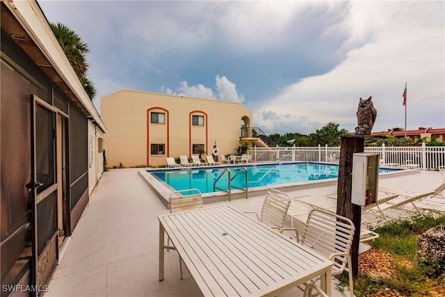 view of swimming pool with a patio area