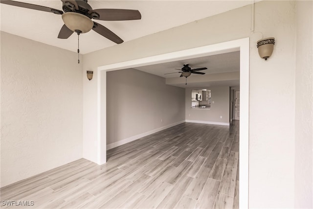 spare room featuring light hardwood / wood-style flooring and ceiling fan