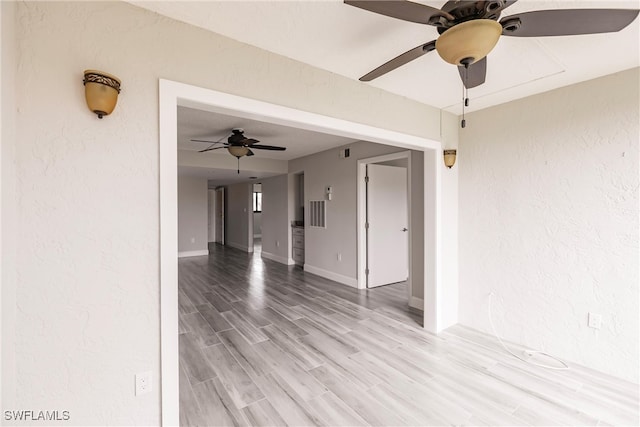 empty room featuring hardwood / wood-style floors and ceiling fan