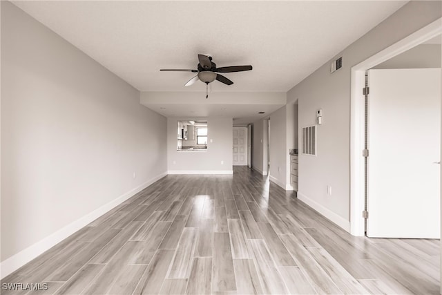 spare room featuring light hardwood / wood-style flooring and ceiling fan