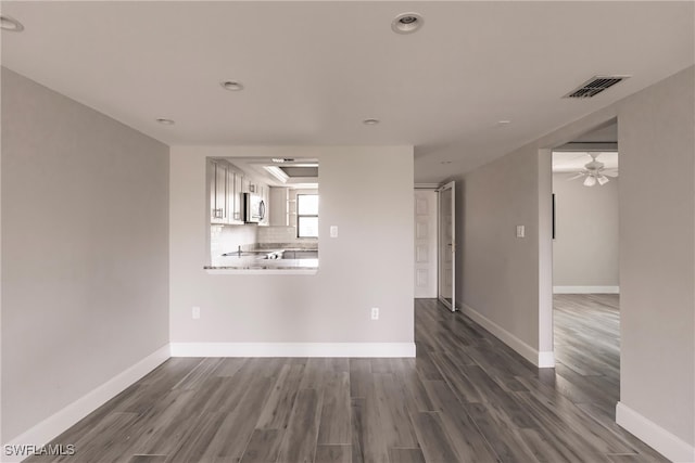 unfurnished room with ceiling fan and dark hardwood / wood-style floors