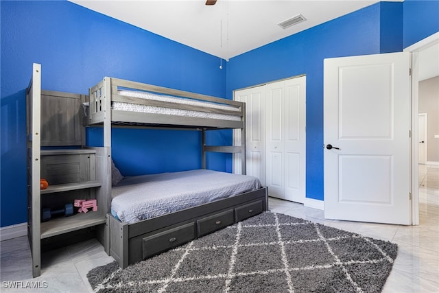 tiled bedroom featuring a closet and ceiling fan