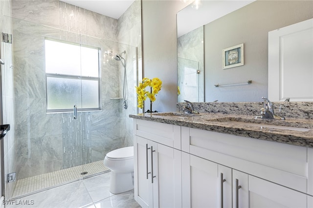 bathroom featuring tile patterned floors, a shower with shower door, vanity, and toilet