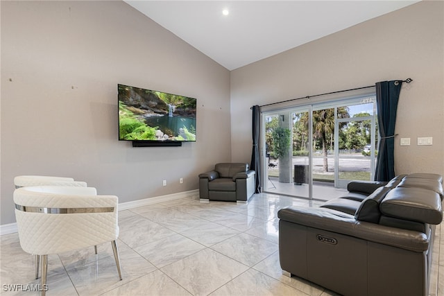 living room with high vaulted ceiling and light tile patterned flooring