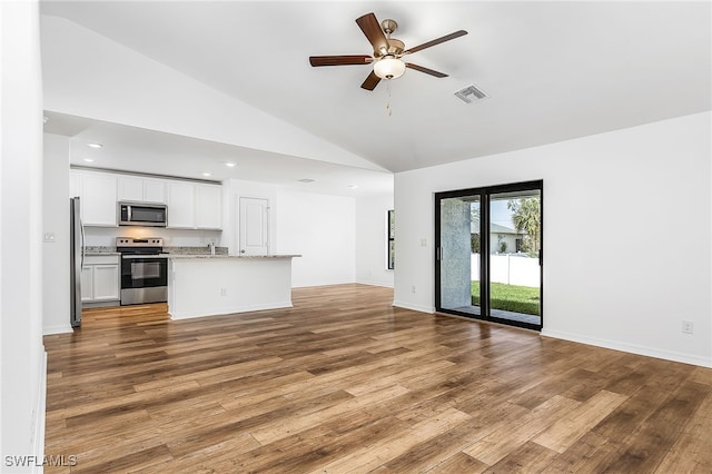 unfurnished living room with light hardwood / wood-style flooring, ceiling fan, and high vaulted ceiling