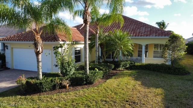 view of front of property featuring a garage and a front yard