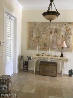 interior space with crown molding and tile patterned flooring