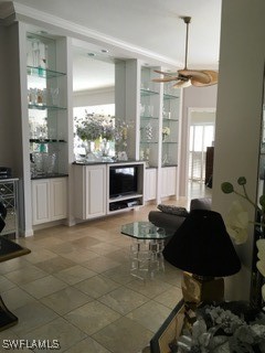 bar featuring ceiling fan, hanging light fixtures, tile patterned floors, and white cabinets