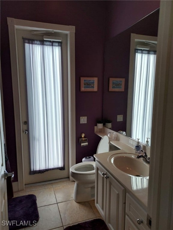 bathroom featuring tile patterned floors, toilet, and vanity