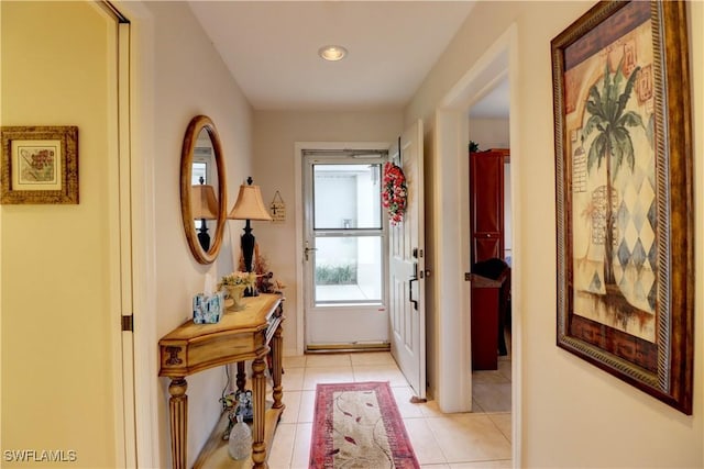 doorway with light tile patterned flooring