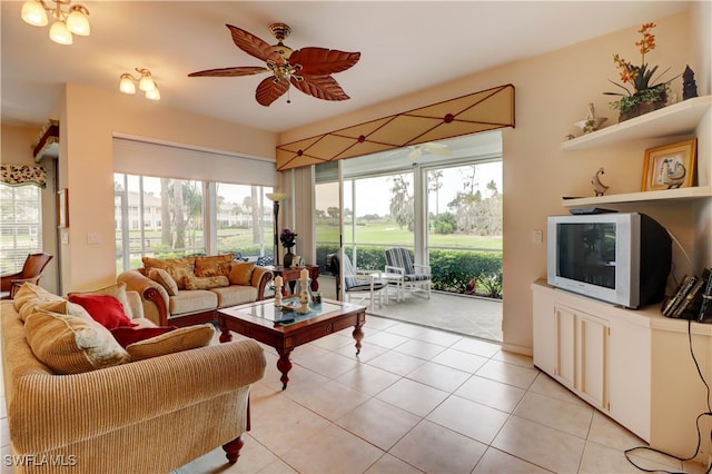 living room featuring ceiling fan with notable chandelier and light tile patterned flooring