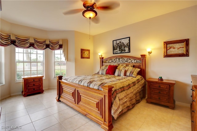 bedroom featuring light tile patterned floors, baseboards, and a ceiling fan