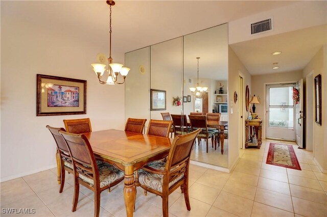 dining area featuring an inviting chandelier and light tile patterned floors