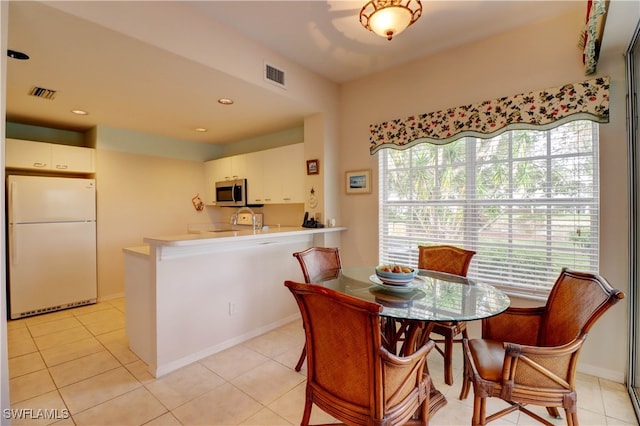 dining room featuring light tile patterned flooring