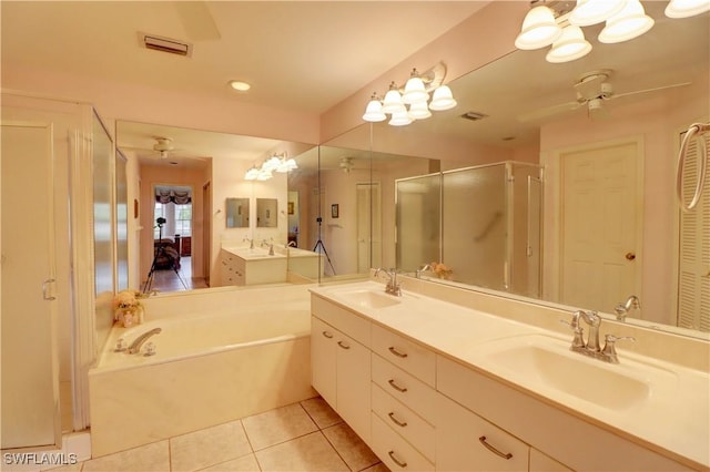 bathroom with ceiling fan, tile patterned flooring, a sink, a shower stall, and double vanity