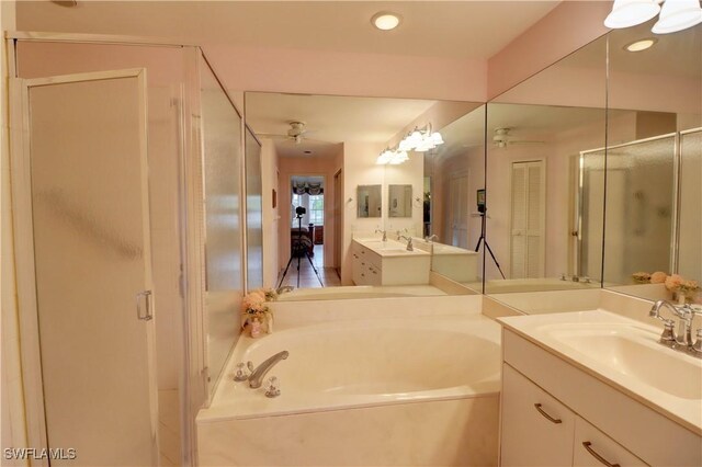 bathroom featuring ceiling fan, independent shower and bath, and vanity