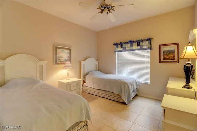 bedroom featuring light tile patterned flooring, a ceiling fan, and baseboards