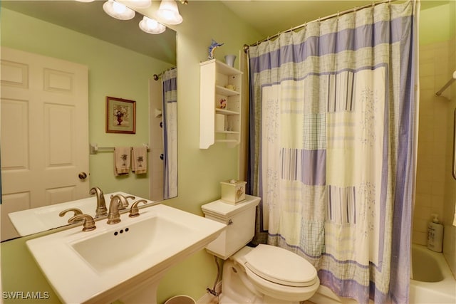 full bathroom featuring shower / bath combo, toilet, and sink