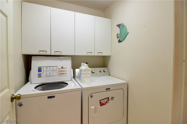 washroom featuring cabinet space and washer and dryer