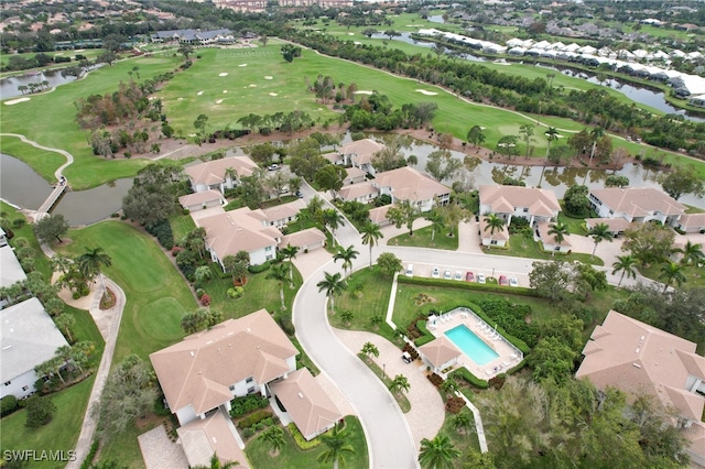 birds eye view of property featuring view of golf course, a water view, and a residential view