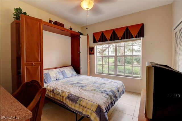 bedroom featuring light tile patterned floors and baseboards