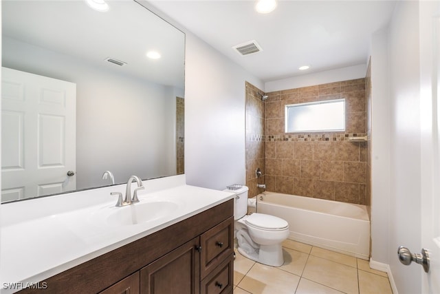 full bathroom featuring vanity, tile patterned floors, toilet, and tiled shower / bath