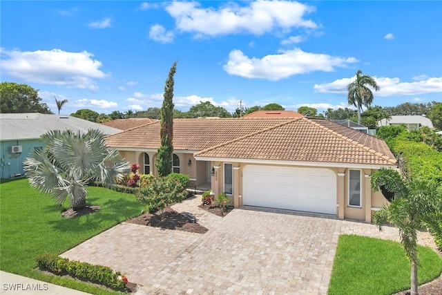 view of front of house with a garage and a front lawn