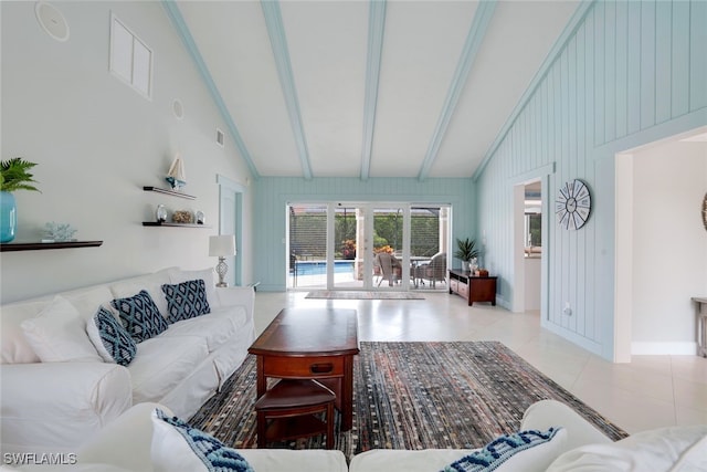 tiled living room featuring french doors, wooden walls, and vaulted ceiling with beams