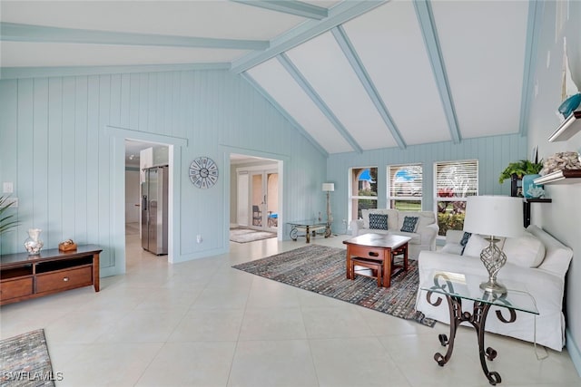 tiled living room with wooden walls and vaulted ceiling with beams