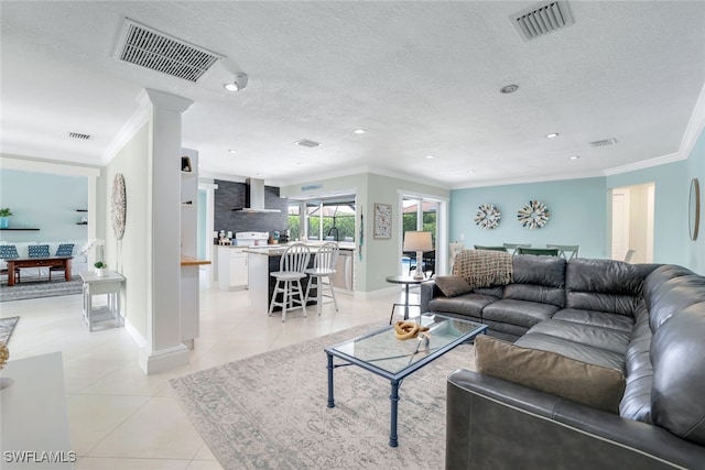 tiled living room with a textured ceiling and crown molding