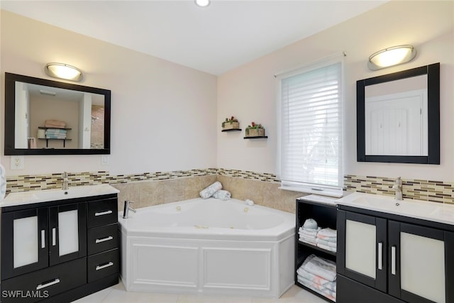 bathroom with a tub to relax in, decorative backsplash, and vanity