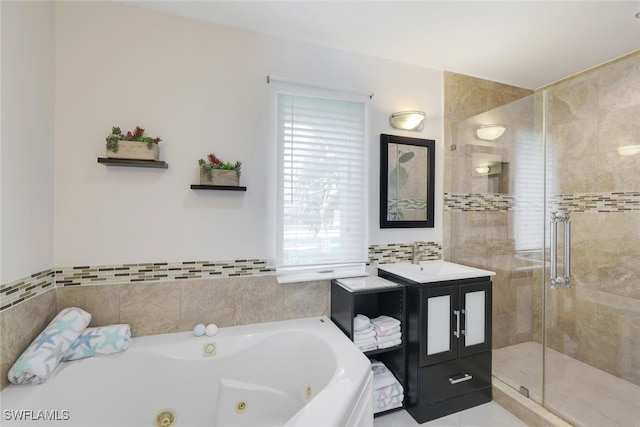 bathroom with vanity and shower with separate bathtub