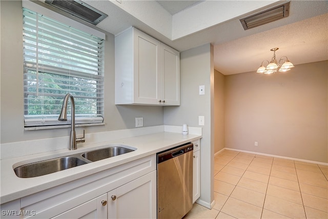 kitchen featuring white cabinets, pendant lighting, sink, stainless steel dishwasher, and a notable chandelier