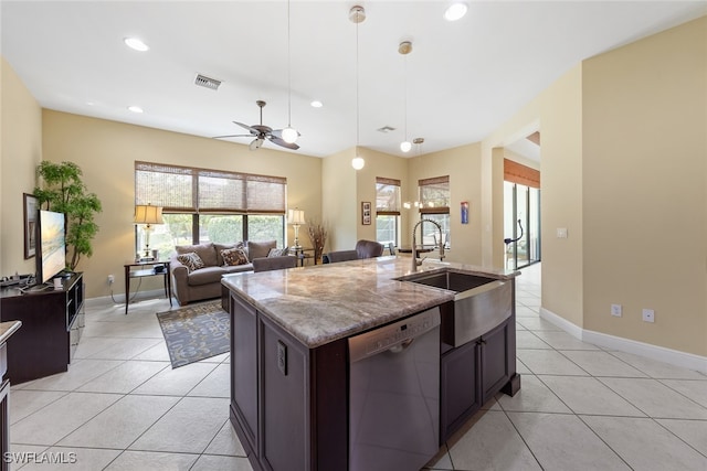 kitchen featuring dishwasher, decorative light fixtures, sink, an island with sink, and ceiling fan