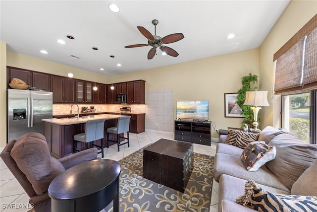 living room featuring ceiling fan and light tile patterned floors