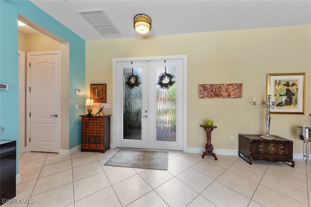 tiled foyer entrance featuring french doors