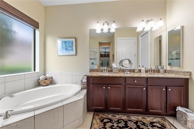 bathroom with tile patterned flooring, separate shower and tub, and vanity