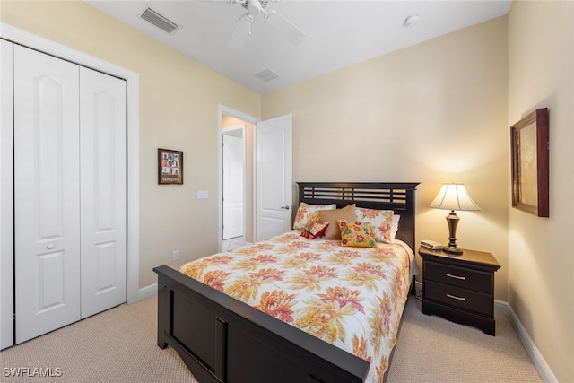 carpeted bedroom featuring ceiling fan and a closet