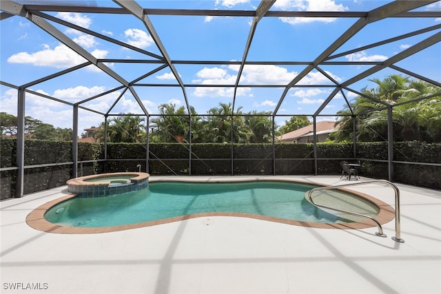 view of swimming pool featuring glass enclosure, an in ground hot tub, and a patio area