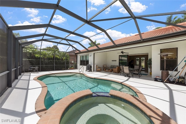 view of swimming pool featuring a lanai, an in ground hot tub, ceiling fan, and a patio