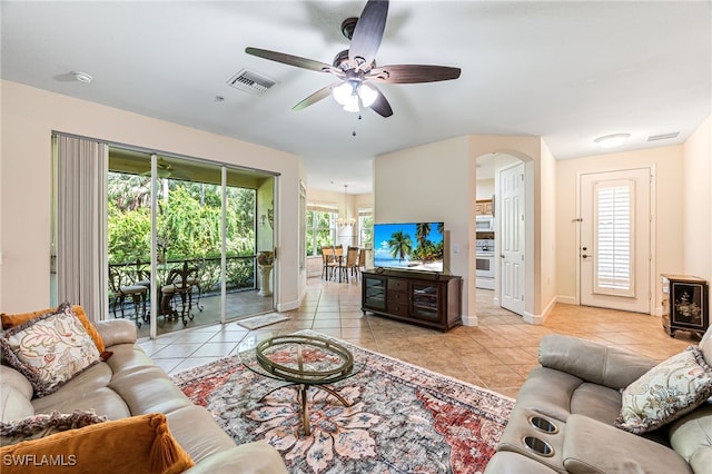 living room featuring light tile patterned floors and ceiling fan