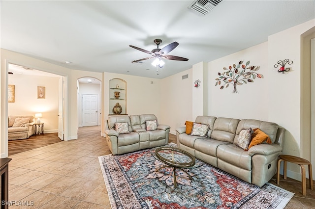 living room featuring light tile patterned floors and ceiling fan