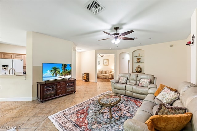 living room featuring light tile patterned flooring and ceiling fan