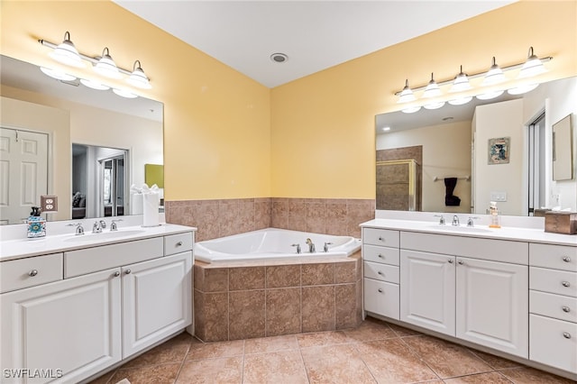 bathroom featuring tile patterned floors, shower with separate bathtub, and vanity