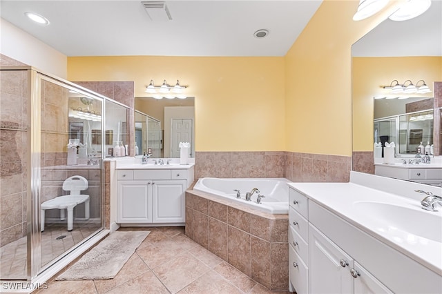 bathroom featuring tile patterned floors, independent shower and bath, and vanity