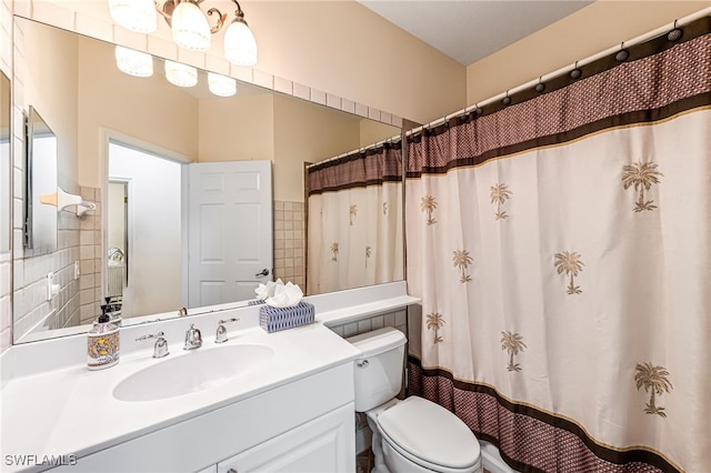 bathroom with vanity, toilet, and a shower with shower curtain