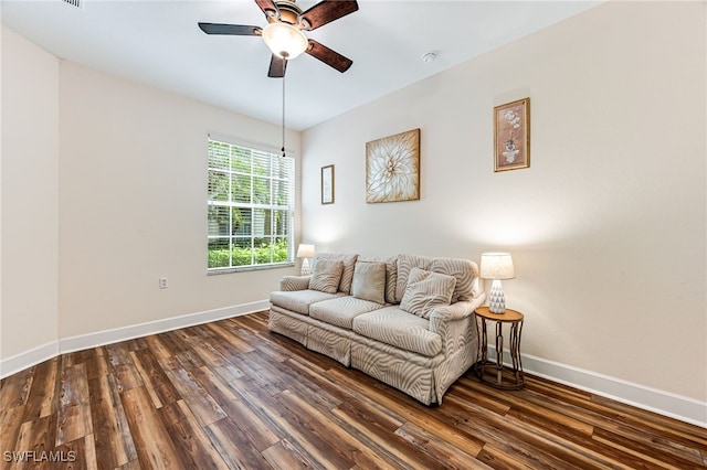 living area featuring ceiling fan and dark hardwood / wood-style flooring