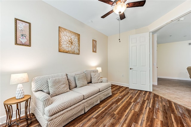 living room featuring dark hardwood / wood-style flooring and ceiling fan