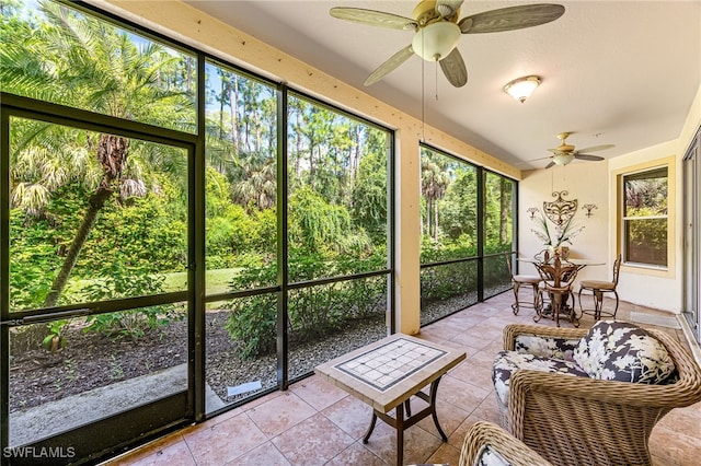 sunroom / solarium featuring ceiling fan