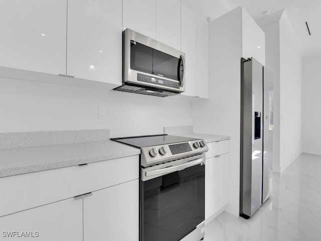 kitchen with stainless steel appliances and white cabinetry